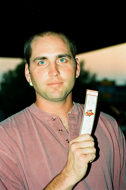 Billy Ripken holding a ticket to see his brother Cal break a record