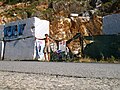 Blocks of marble in Carrara marble quarry with a tourist for scale 6385.jpg