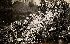 Char fleuri transportant cinq jeunes filles.