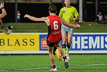 Pearce kicking the ball during a match in 2017