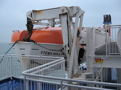 Gravity multi pivot davit holding rescue vessel on North Sea ferry