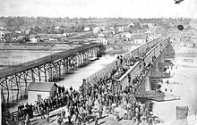 The dedication of Dixon's Truesdell Bridge, Jan. 21, 1869. View: looking north. Dedication of the Dixon Bridge, 1869.jpg