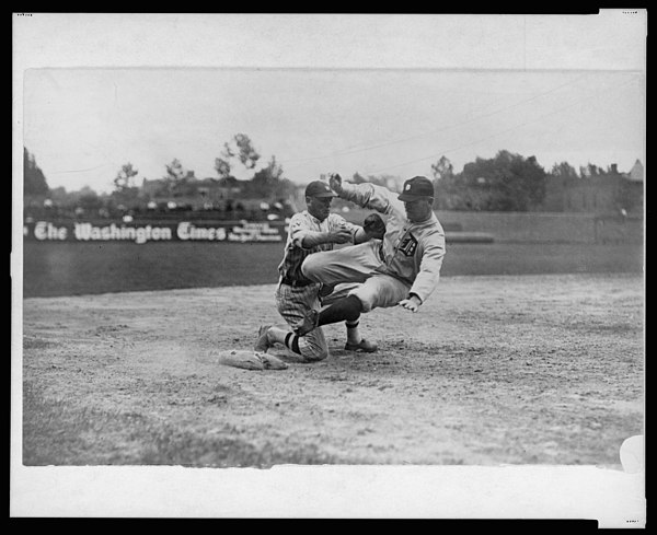 Harry Heilmann, in a poorly executed slide, is tagged out by Washington Senators' third baseman Howard Shanks, 1921.