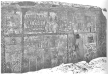 Susan Hopkins pointing to the figure of Moses with the detail showing the Aramaic inscription Dura-Europos wall painting Aramaic Moses inscription.png