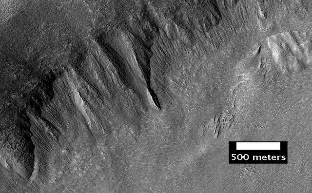 Place where a lobate debris apron begins. Note stripes which indicate movement. Image located in Ismenius Lacus quadrangle.