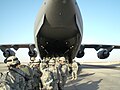 United States Army soldiers board aircraft in Kuwait in order to move to Baghdad, Iraq.