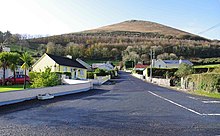 Road approaching the village of Glenosheen, viewed from the R512 junction, with the Ballyhoura mountain range in the background. Glenosheen Village - geograph.org.uk - 1571355.jpg