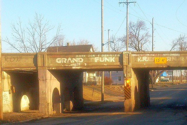 A Grand Trunk Western Railroad bridge (located at 42°59'56.2"N 83°41'35.6"W) in Grand Funk's hometown of Flint, Michigan, that was re-painted to inste