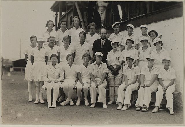Photo from 1934–35 England tour of Australia and New Zealand. The England team (L) wear divided skirts and white stockings. The "Woollengong" (sic) wo