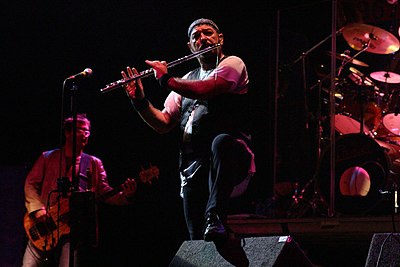 Ian Anderson, the lead vocalist, flautist, acoustic guitarist and principal songwriter of Jethro Tull, performing with the band in Oxfordshire, England in 2004