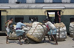 Pushing cotton bales in a railway station Calcutta Kolkata India