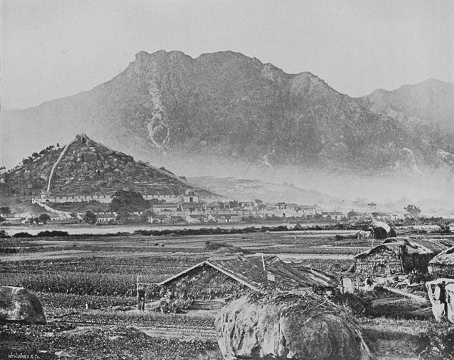 Kowloon c. 1868, depicting the Qing-era Kowloon Walled City and Lion Rock (in the background)