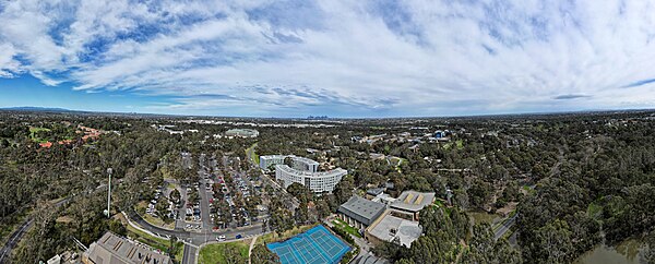 La Trobe University Bundoora Campus aerial panorama, facing south towards the city skyline. September 2023.