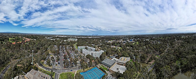 File:La Trobe University Bundoora Campus aerial panorama, facing south towards the city skyline. September 2023.jpg