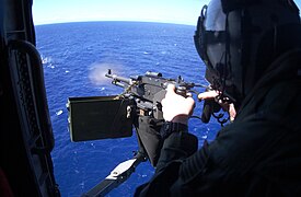 An M240D machine gun is fired from a SH-60F Sea Hawk