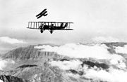 Martin MB-2 in flight with a pursuit aircraft practicing an attack 061219-F-1234S-016