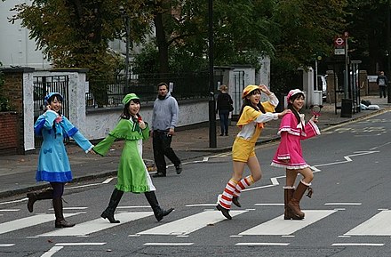 The four voice actresses of the Japanese manga/media franchise Milky Holmes reenacting the famous cover of the Beatles album Abbey Road (1969) during their London visit in 2010