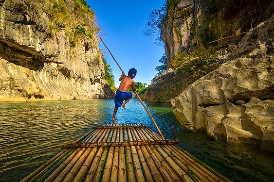 A young boy maneuvers a raft in Minalungao Protected National Park in General Tinio, Nueva Ecija. Photograph: Jsinglador