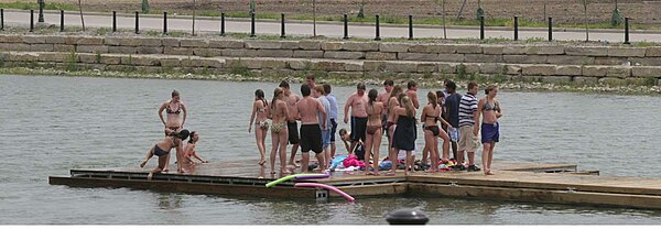 People standing on a dock at one of the swimming lakes of New Town NewTownLakeSwimming.jpg