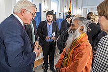 Paskaran talking with the federal president Steinmeier. PaskaranSteinmeier.jpg