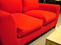 A red two-seater upholstered loveseat