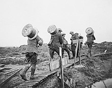 Royal Engineers bringing up telephone cable during the Battle of Poelcappelle. Royal Engineers bringing up telephone wire Battle of Poelcappelle 1917 IWM Q 6050.jpg