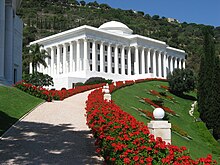 A white building with several columns and a domed roof