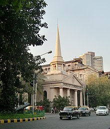 St Andrew, with a Neoclassical facade, is located opposite the Lion Gate. St Andrew's church, Mumbai.jpeg