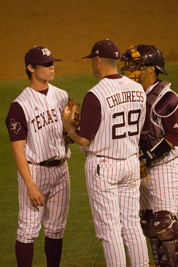 Head Coach Rob Childress on the mound, instructing an Aggie pitcher.