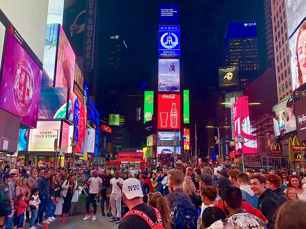 crowd of people in times square new york city at night