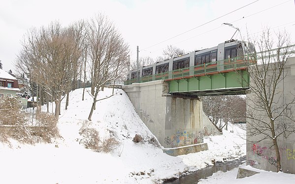 Snowy tram bridge over a stream in southern Vienna