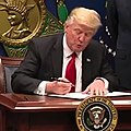Donald Trump, signing an executive order on travel and immigration to the U.S. from seven Muslim-majority countries, on January 27, 2017