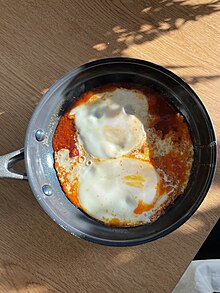 Ojja is a dish with a base of eggs, harissa, and tomato paste Tunisian Ojja.jpg