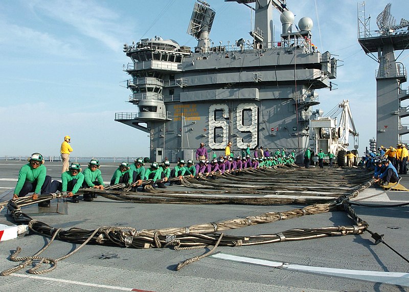 File:US Navy 050926-N-7359L-001 Air Department personnel assigned to the Nimitz-class aircraft carrier USS Dwight D. Eisenhower (CVN 69), assemble the emergency-landing barricade net on the flight deck during a training drill in por.jpg