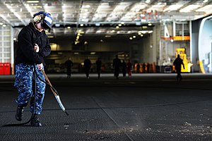 US Navy 120124-N-XE109-014 Aviation Boatswain's Mate Airman Danielle M. Jones cleans the hangar bay of the aircraft carrier USS George H.W. Bush (C.jpg