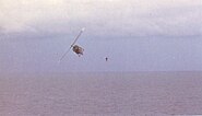 VNAF pilot jumps from his Huey after dropping evacuees on USS Midway