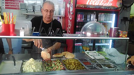 The owner fills a pita with falafel at Falafel HaZkenim