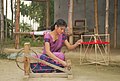 Assamese young woman prepares for weaving
