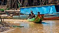 A man and his sons in a boat (Kampong Phluk, Cambodia).jpg