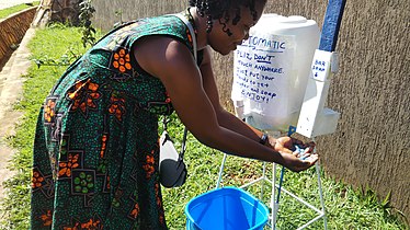 Getting soap from a touchless solid bar soap dispenser Photo by Wabyona Bingi