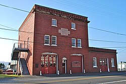 Fotografia di un edificio in mattoni a tre piani con un cartello nel riquadro con la scritta "Caserma dei pompieri n. 2"