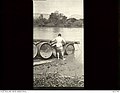 Australian soldier assisting to launch a barrel pier into the Jordan river.jpg