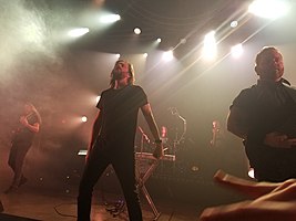 Between the Buried and Me performing in August 2018 From left to right: Paul Waggoner, Tommy Giles Rogers Jr., Blake Richardson, Dan Briggs, Dustie Waring