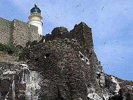 The remains of the castle in 2007, and the lighthouse