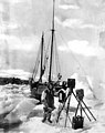 CW Scarborough in front of the schooner TEDDY BEAR with his photographic equipment, Siberian Coast, 1922 (AL+CA 4928).jpg