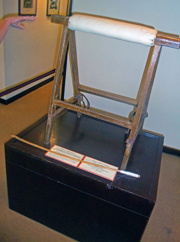 Caning stand and cane formerly used in Hong Kong prisons under British rule