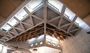 Nave of Clifton Cathedral, showing concrete structures and engineering, acoustic baffles and 'hidden' windows (including star beam in lower part, with hexagonal cutouts) Clifton Cathedral 2018 017.jpg