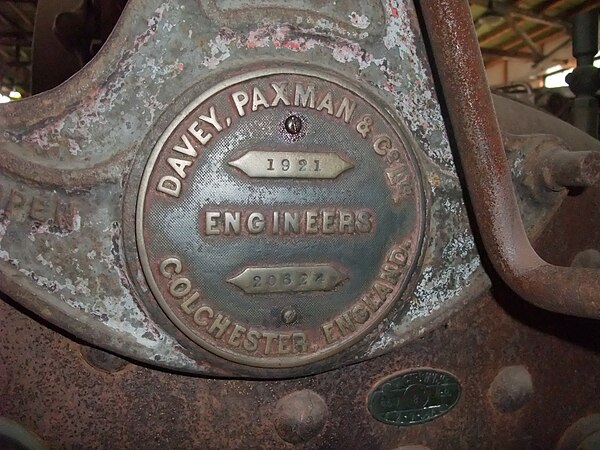 Detail view of same portable engine, showing Paxman builder's plate (dated 1921) on the regulator handle support above the firebox.