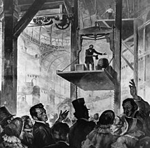 Elisha Otis demonstrating his safety system, at the New York Crystal Palace, 1853 Elisha OTIS 1854.jpg