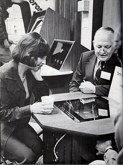 Pauline Sly listens to Dr. David Chandler describe Tank Squadron.